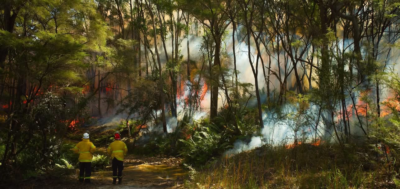 Landscape shot of captain with bush burning in back